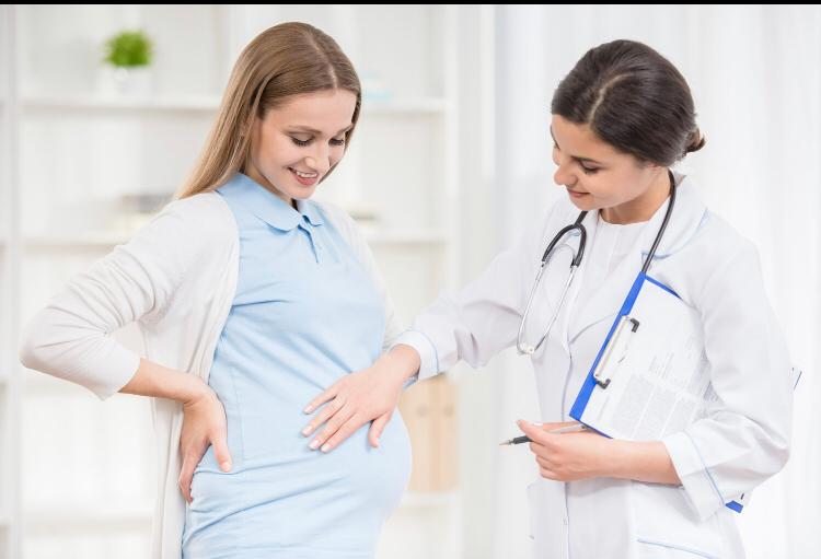 Gynaecology doctor checking pregnant woman for up comming baby